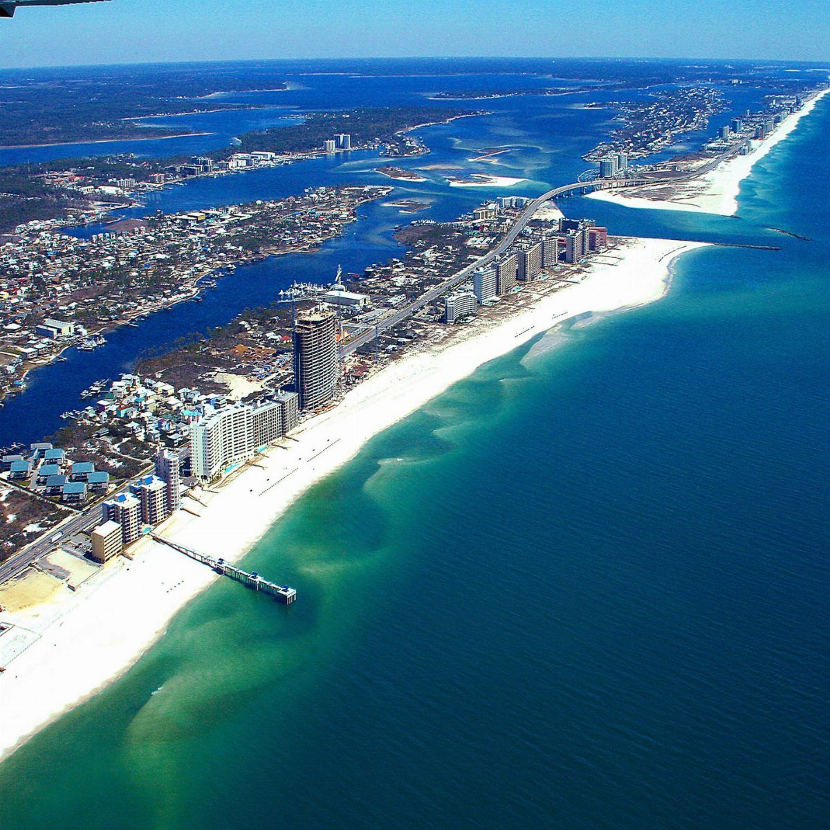 Beach Places to Travel: 13 Ideas for Your Next Trip 10 Aerial view of white sandy beaches and high-rise hotels along a turquoise coastline.