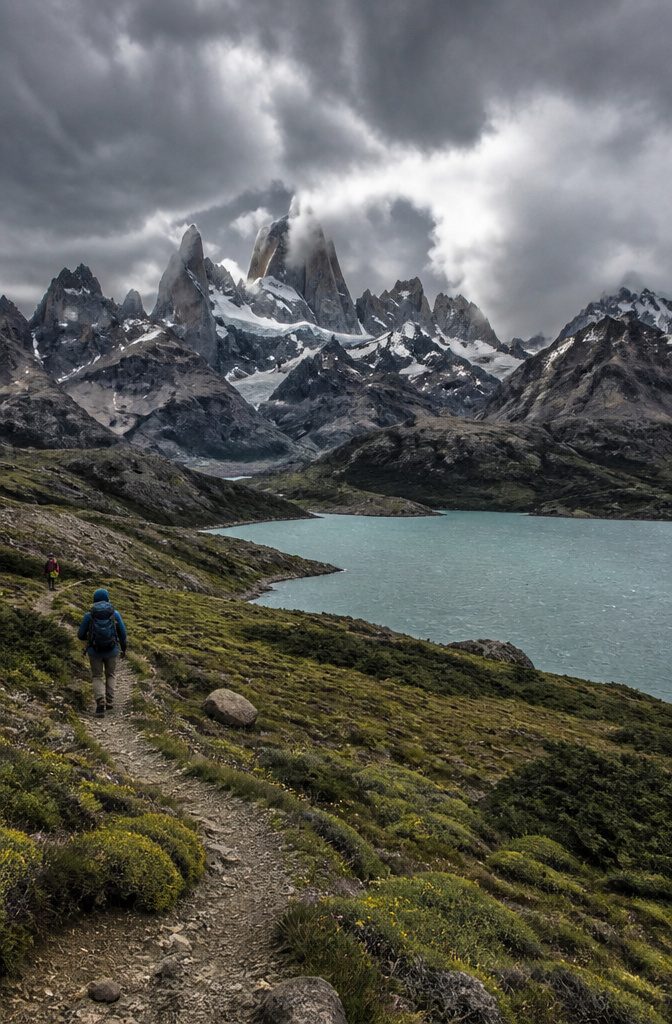 Hikers on a trail with mountains in the background in Patagonia.