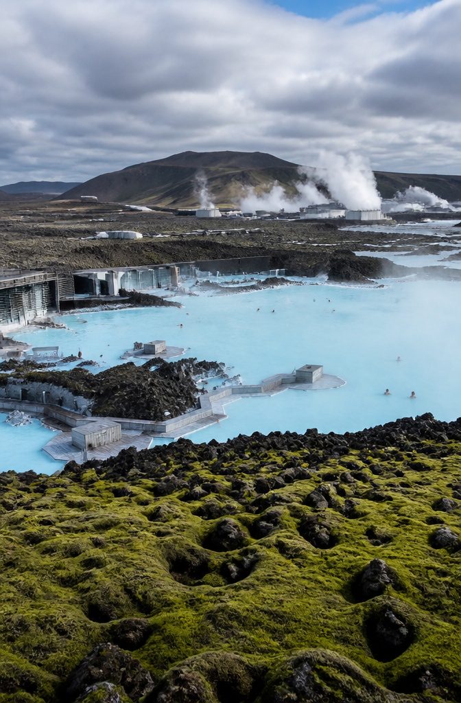 Visitors relaxing in the Blue Lagoon surrounded by lava fields.