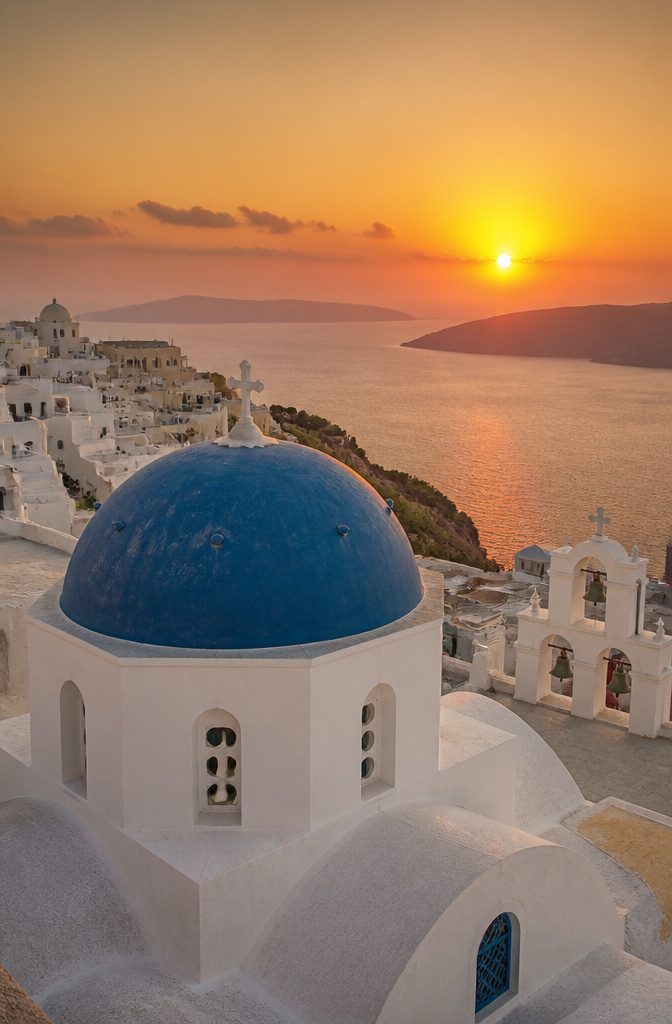 Tourists watching the sunset in Oia, Santorini.