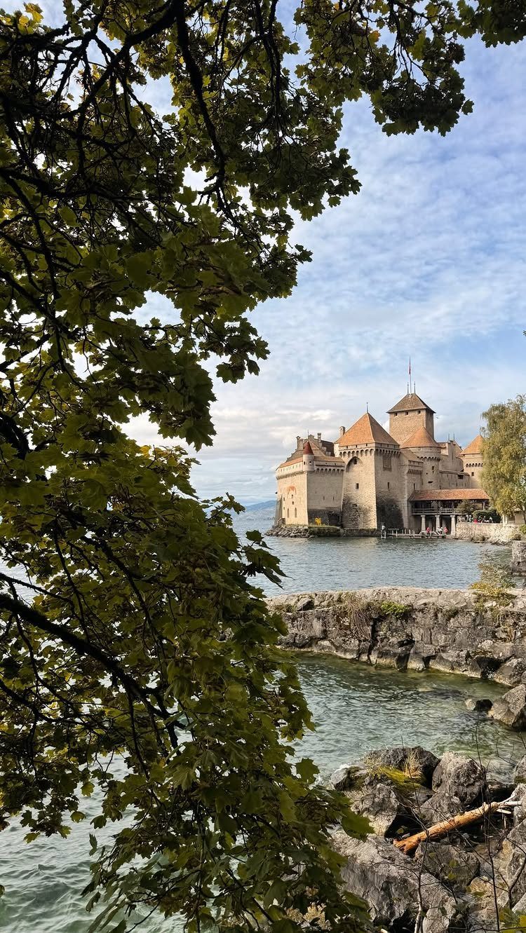 Bucket List Switzerland: 13 Scenic Places and Experiences 7 Château de Chillon medieval castle on the shores of Lake Geneva framed by trees