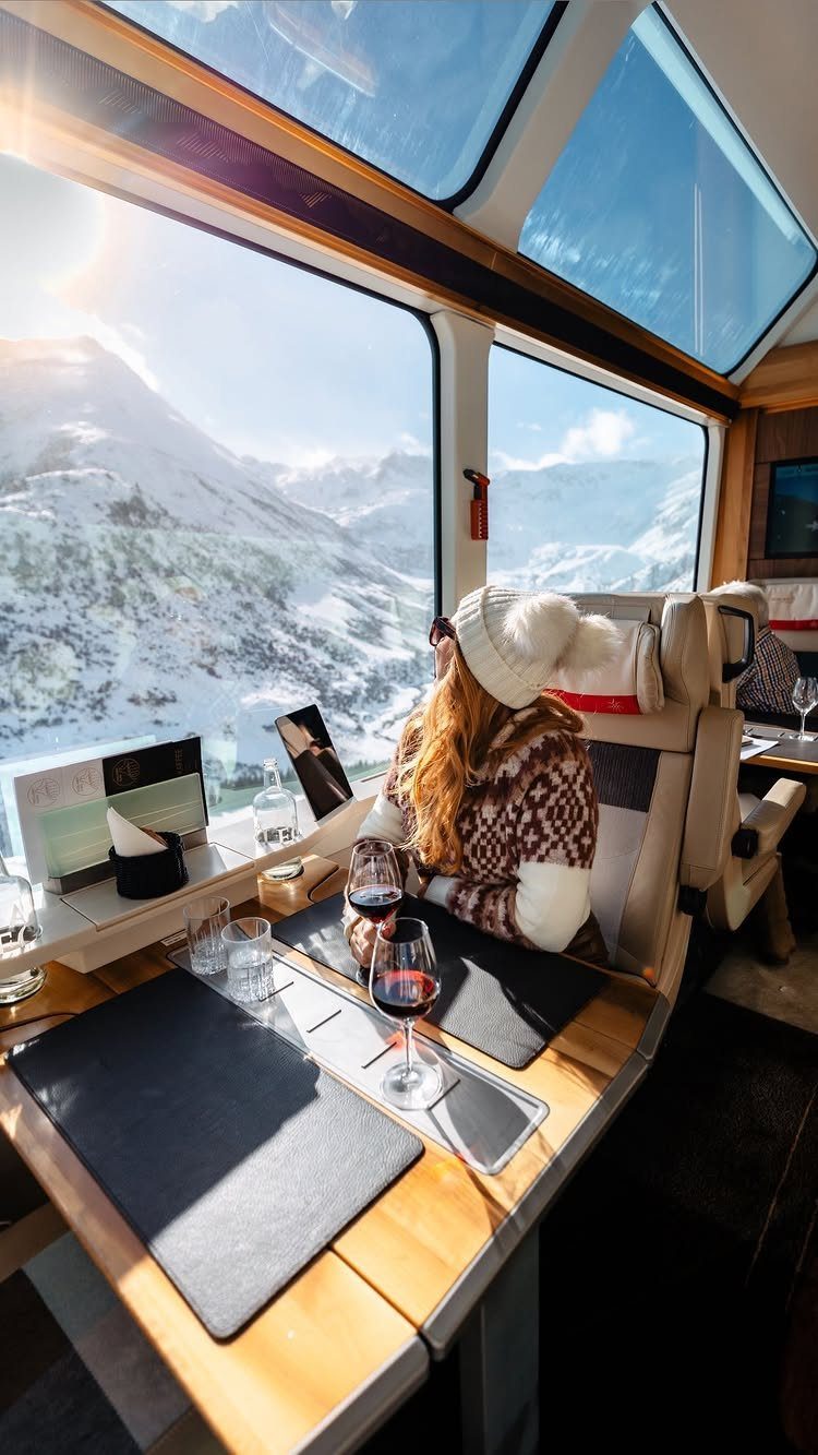 Bucket List Switzerland: 13 Scenic Places and Experiences 6 Woman drinking red wine on a panoramic train overlooking snowy Swiss mountains