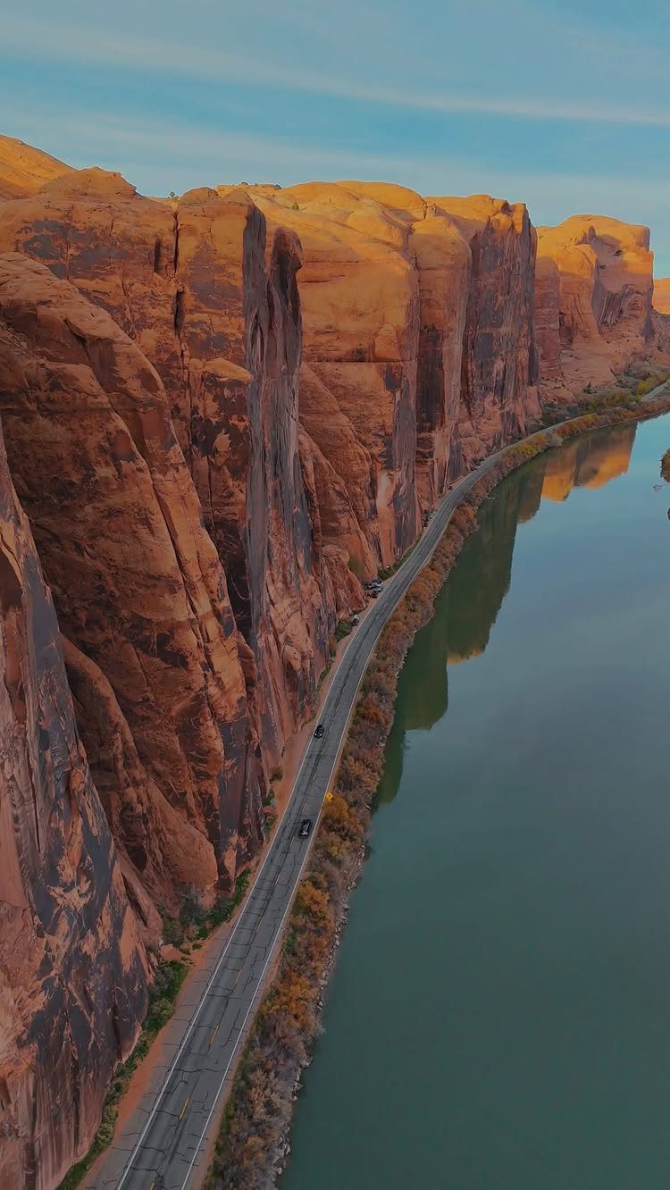 Bucket List Travel Destinations in the USA: 33 Ideas 33 Red sandstone cliffs and a turquoise river beside a winding road in Arizona.