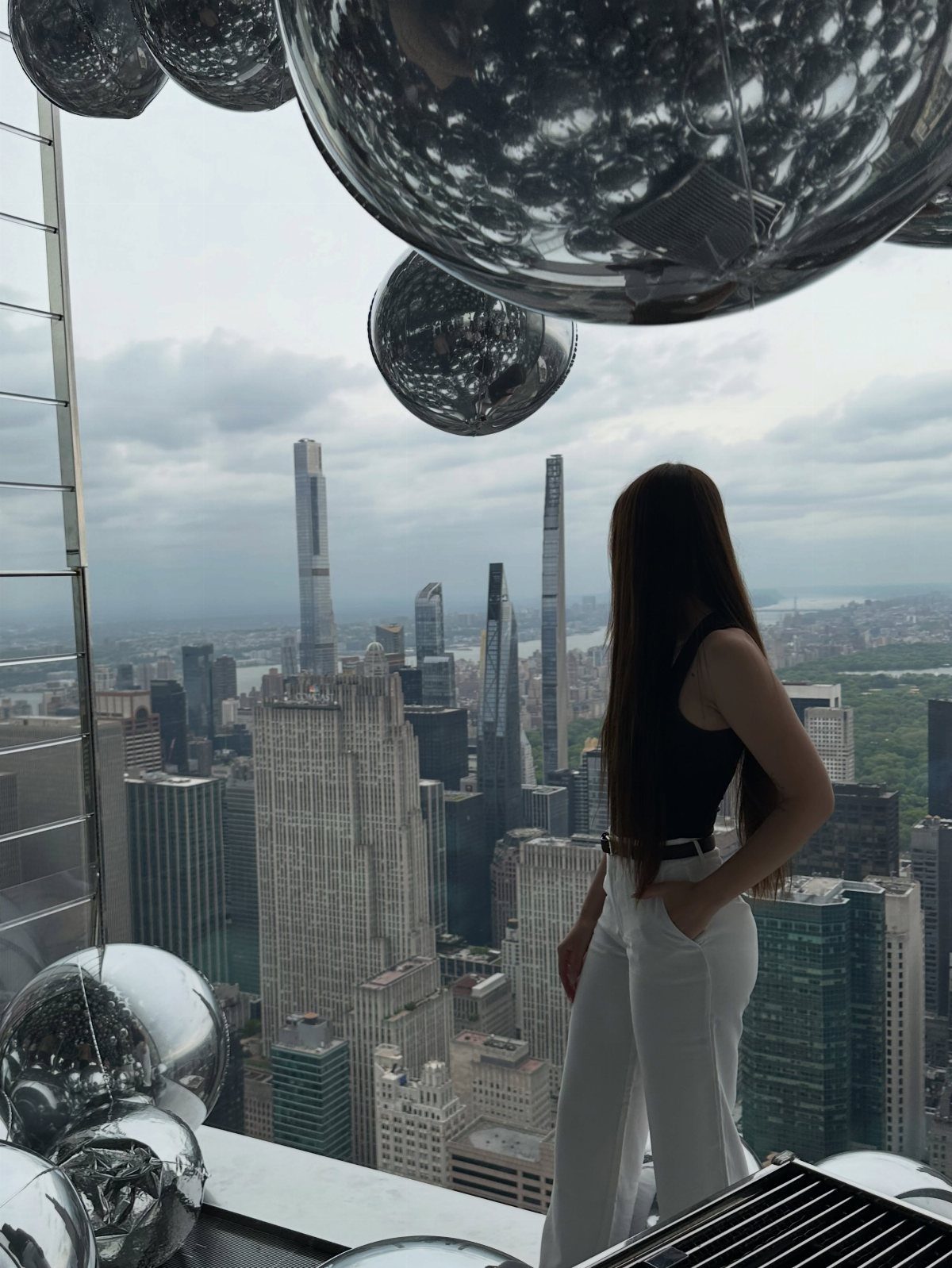 Bucket List Travel Destinations in the USA: 33 Ideas 31 Woman looking at the New York City skyline from a high-rise observation deck