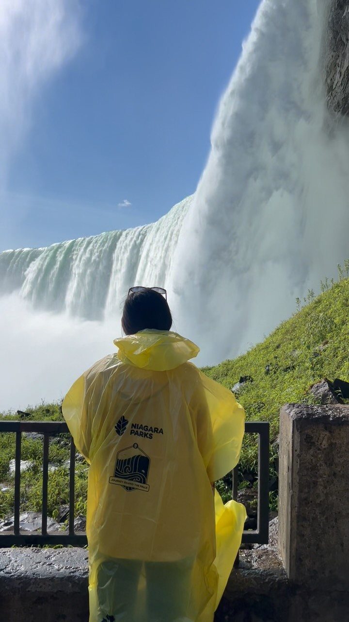 Bucket List Travel Destinations in the USA: 33 Ideas 21 Person in yellow poncho viewing the massive cascading white waters of Niagara Falls.