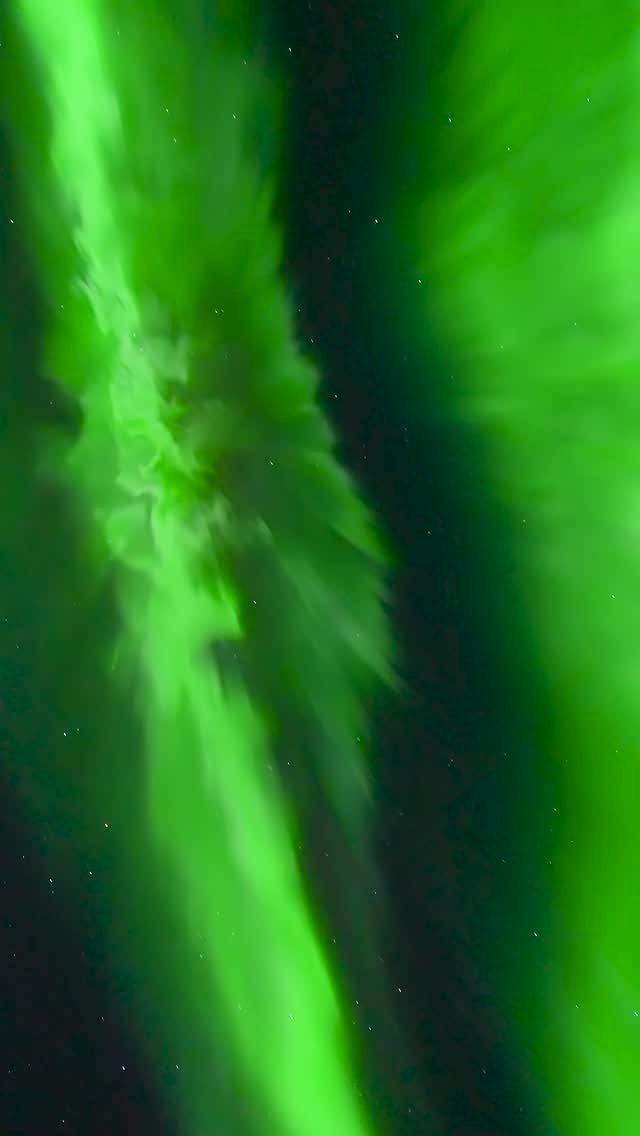 Bucket List Travel Destinations in the USA: 33 Ideas 29 Green aurora borealis lights dancing across a dark starry night sky.