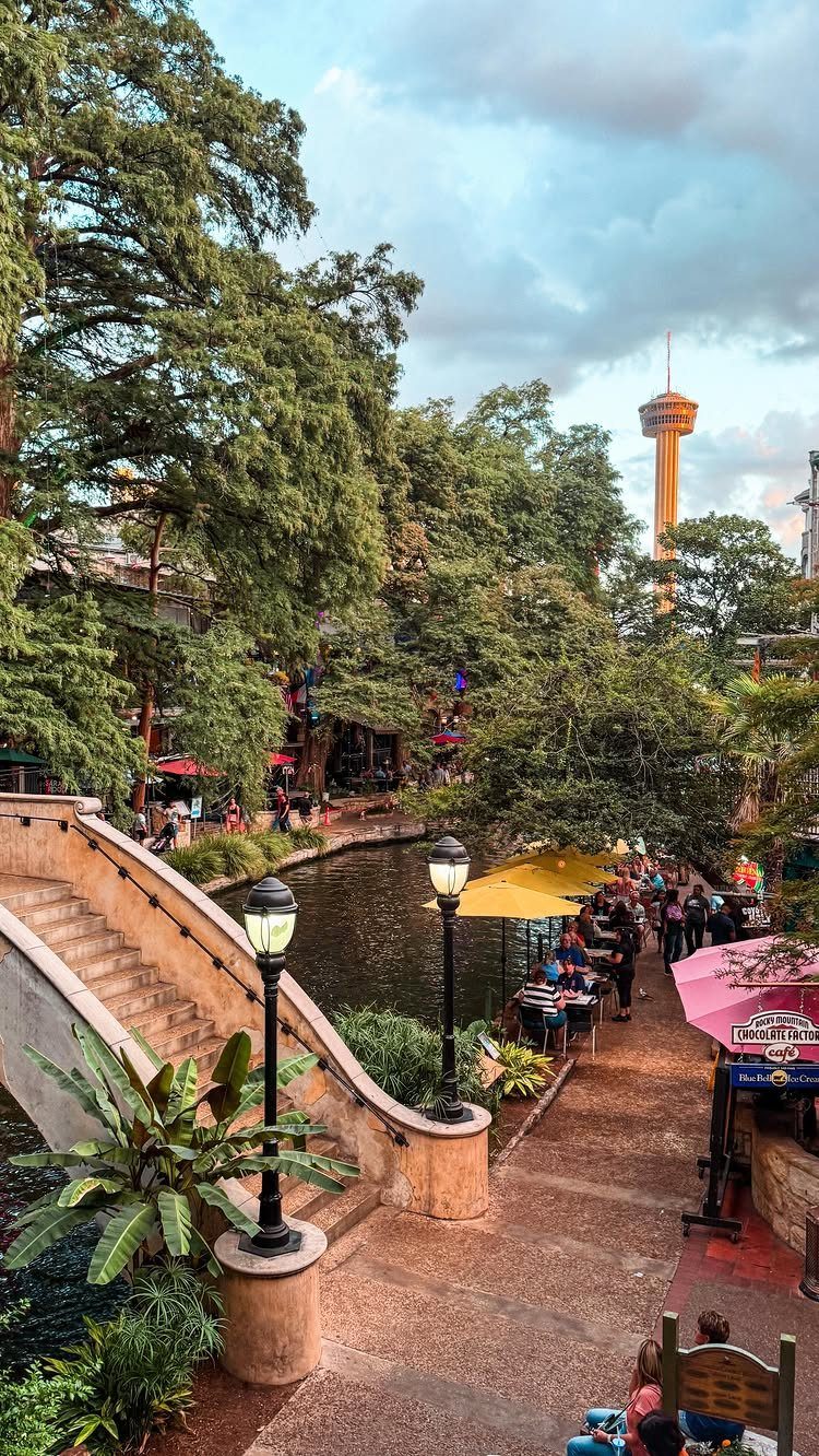 16 Cheap Pretty Places to Travel on a Tight Budget 2 River walk path with stone stairs, lamp posts, and a distant observation tower.