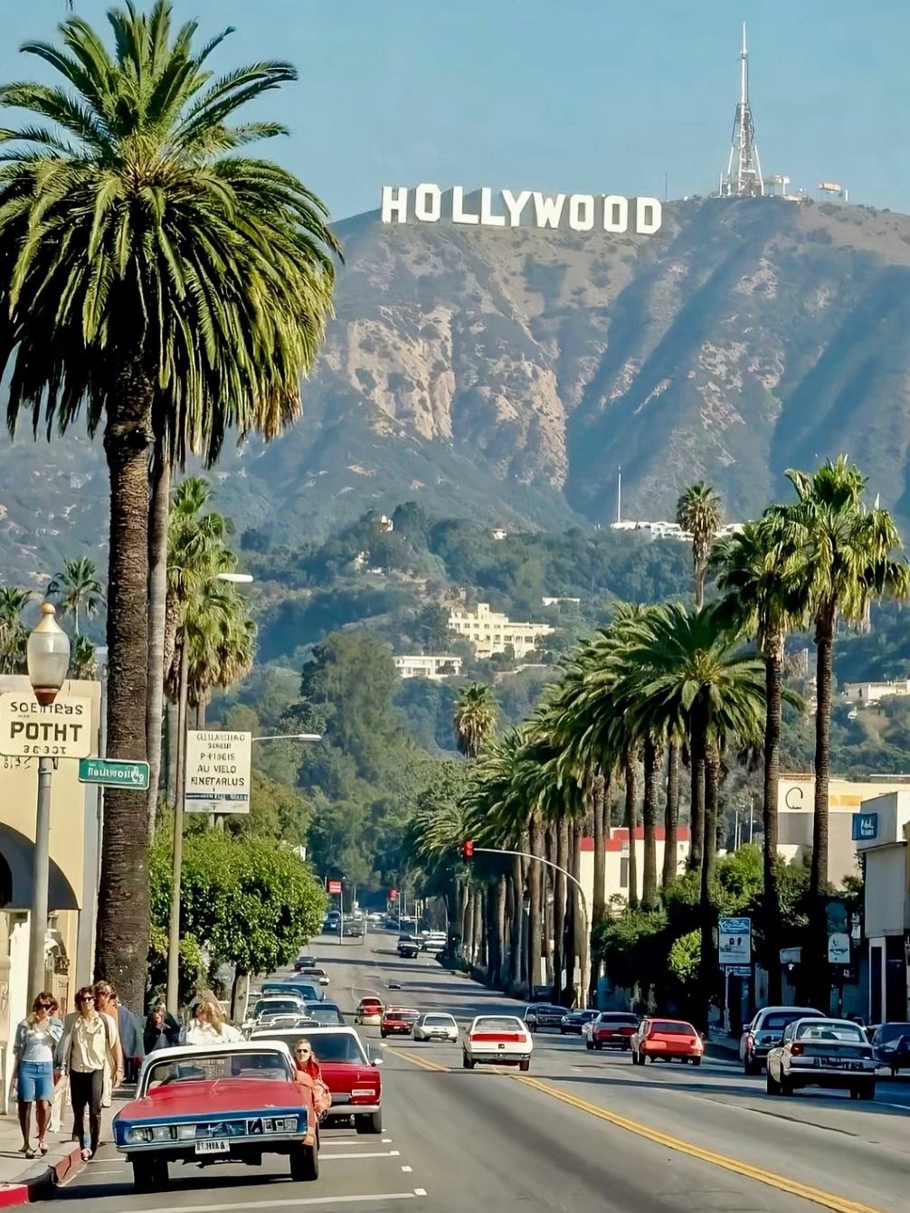 12 Cities to Visit in the U.S. and Abroad for 2026 3 Palm tree lined street with vintage cars and the Hollywood sign on a mountain.