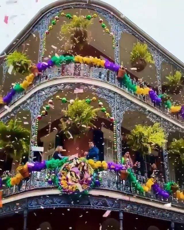 12 Cities to Visit in the U.S. and Abroad for 2026 10 Ornate balconies decorated in Mardi Gras colors with confetti falling in New Orleans.