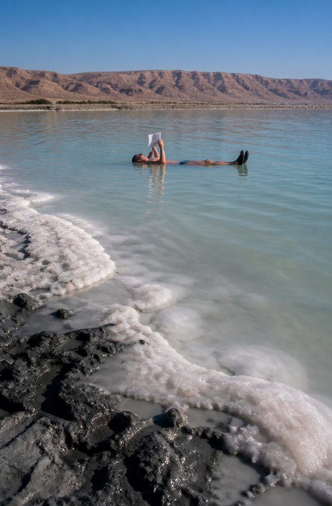 A traveler floating effortlessly in the Dead Sea.