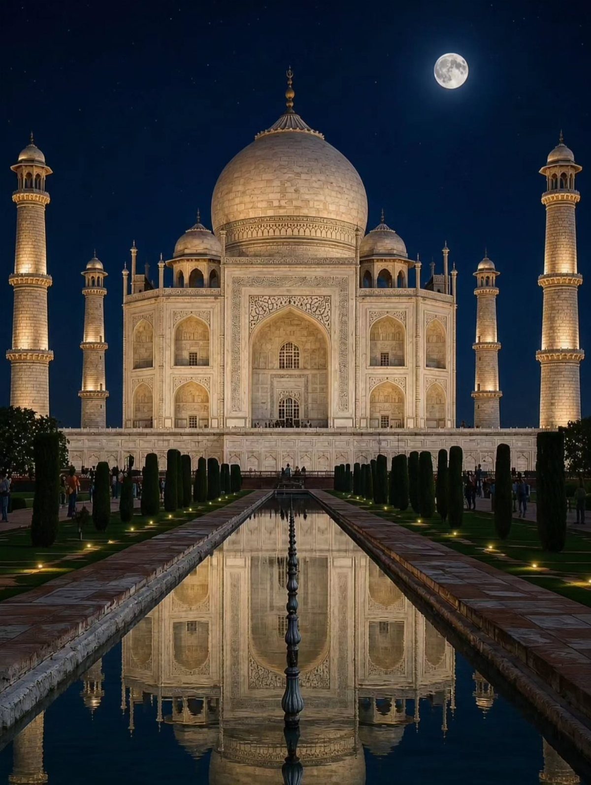 Taj Mahal mausoleum reflected in a pool under a full moon at night