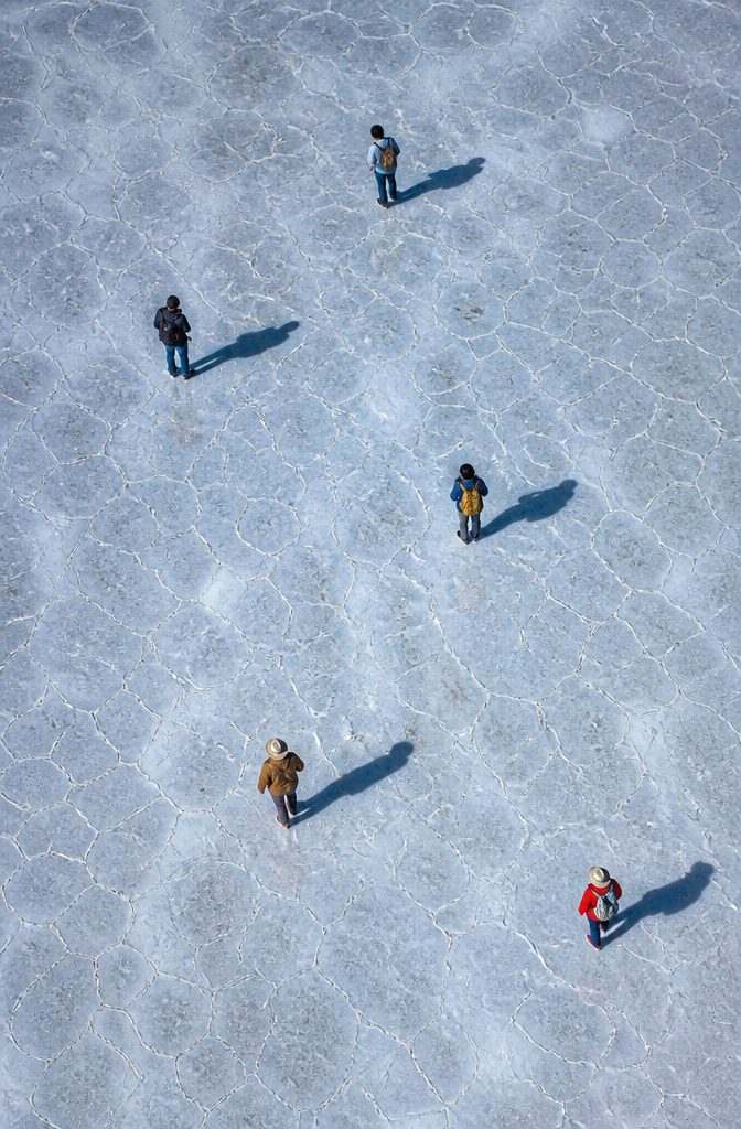 Expansive salt flat of Salar de Uyuni reflecting the sky in Bolivia.