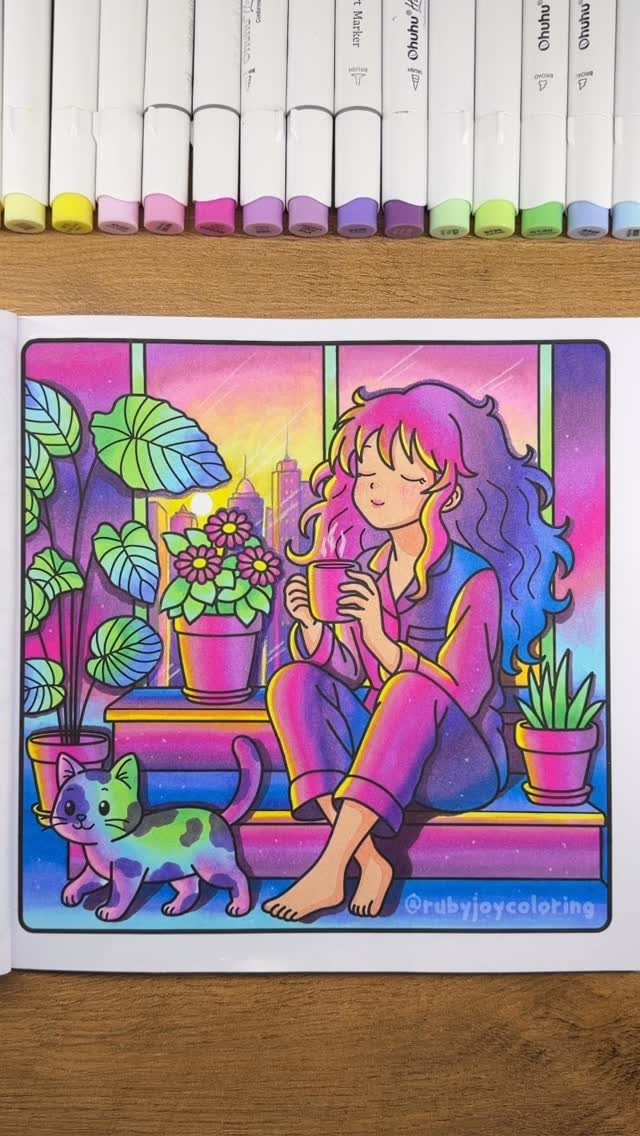 Completed coloring book page of a girl and cat with markers above it.