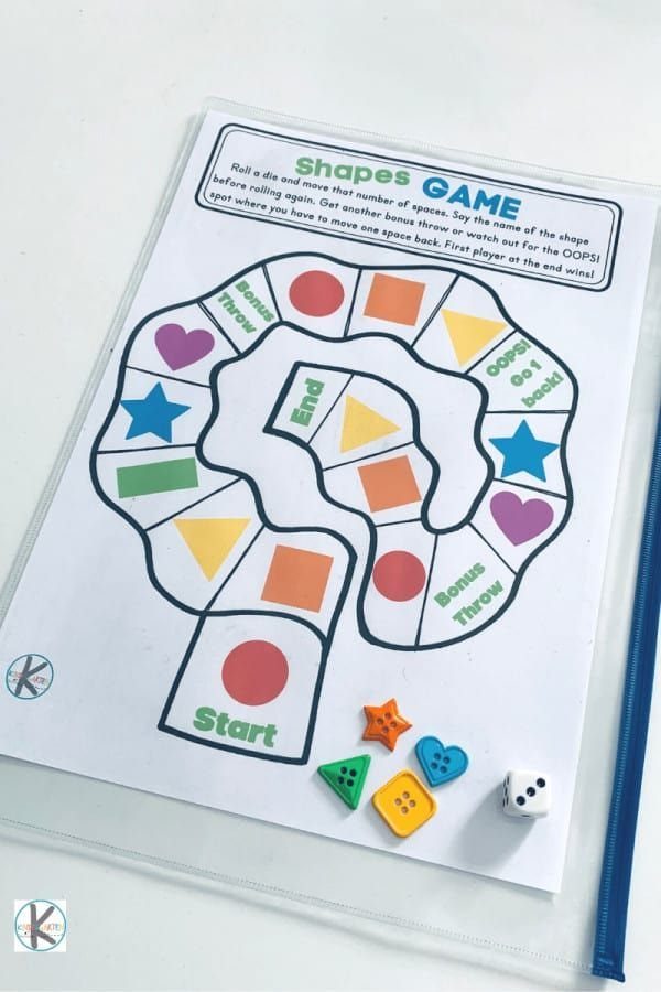 Shapes board game with colorful plastic pieces and a die on a white surface.