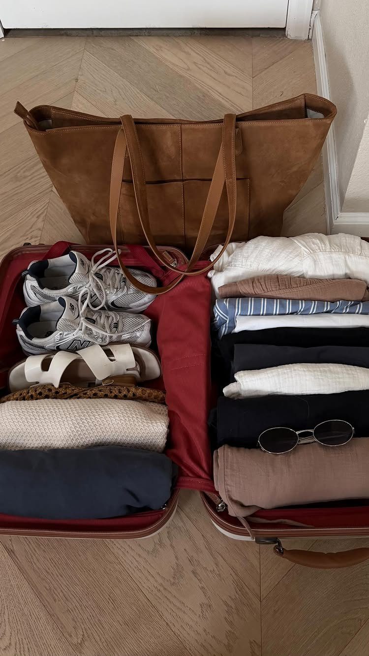 How to Pack for a 3 Week Trip: 7 Packing Ideas 7 Open red suitcase with folded clothes and shoes next to a brown tote bag