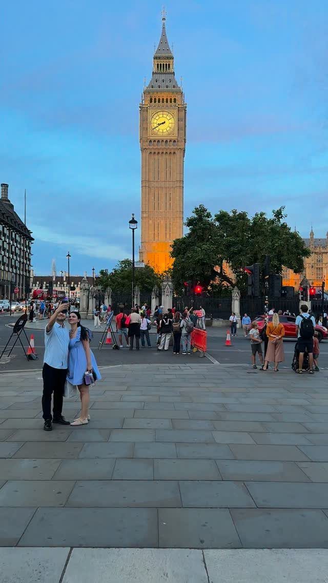 Couple posing on a paved plaza with Big Ben clock tower in the background