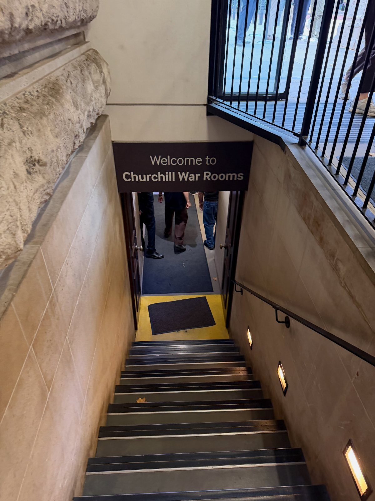 Stairs leading down to the entrance of the Churchill War Rooms museum.