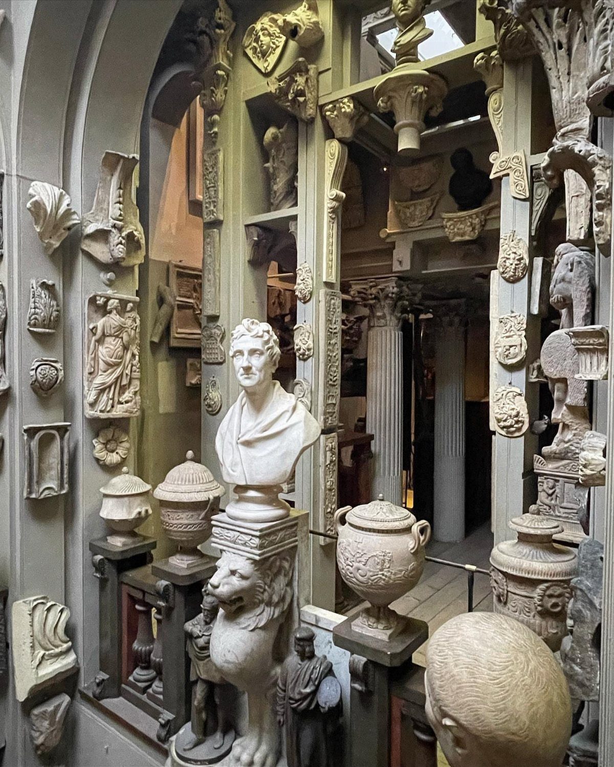 Classical busts and architectural fragments densely displayed inside the Sir John Soane Museum.