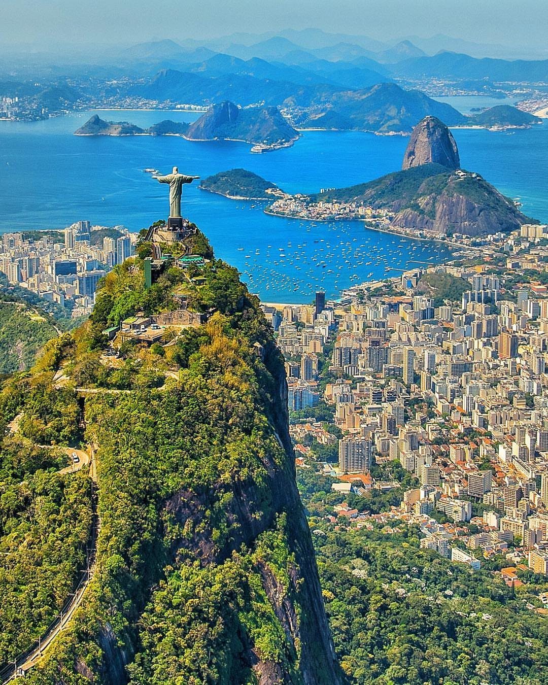 Christ the Redeemer statue overlooking Rio de Janeiro city and the blue ocean coast