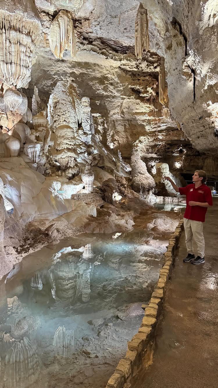 Nature Places to Visit: 19 Parks, Gardens and Overlooks 6 Man in red shirt guiding a tour inside a limestone cavern with stalactites.