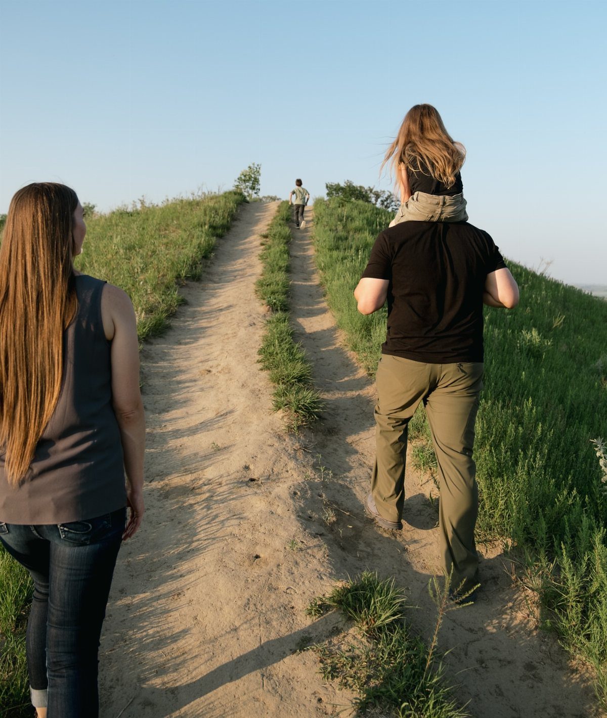 Nature Places to Visit: 19 Parks, Gardens and Overlooks 15 People hiking up a dirt trail on a grassy hill under blue sky