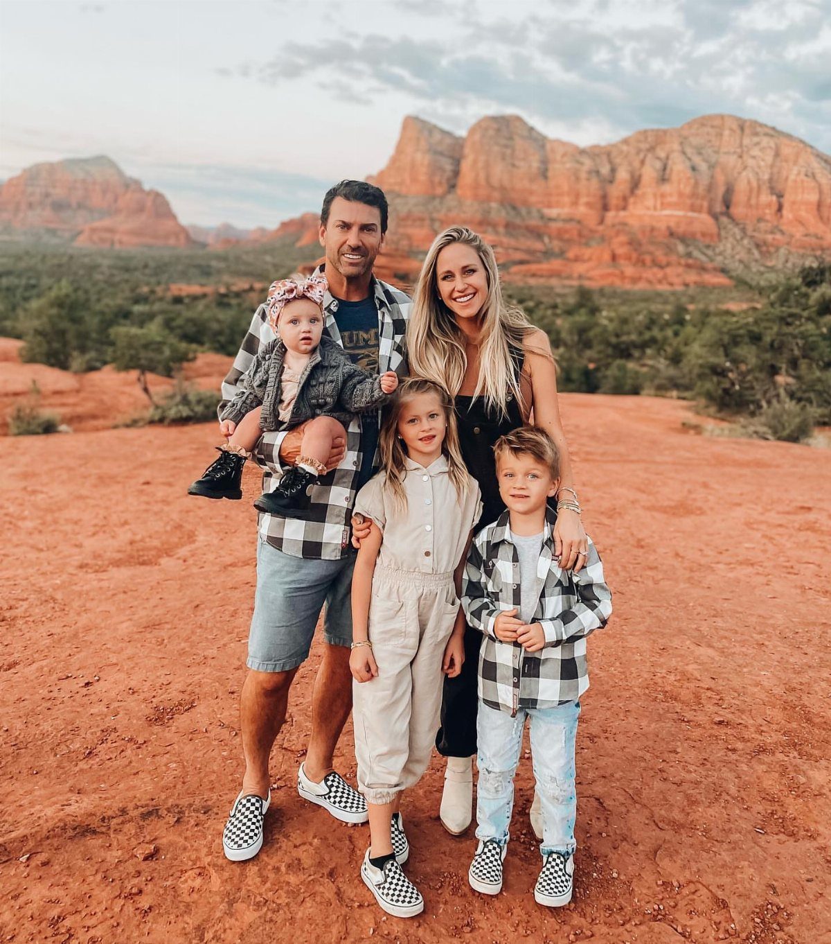 12 November Trip Ideas for Warm Beaches and Fall Color 7 Family posing on red sandy ground with Sedona red rock formations in background