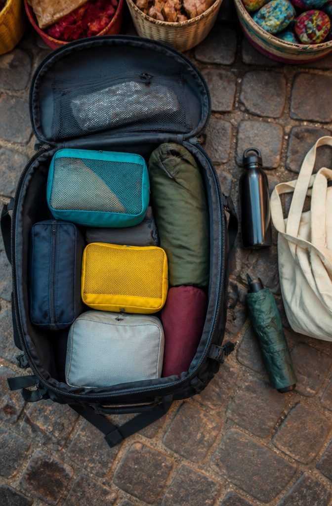 Various packing cubes for organizing clothing in a backpack.