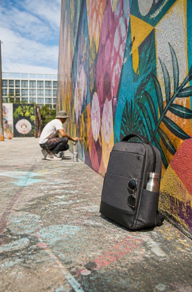 A theft-resistant daypack on a table in a Miami park.