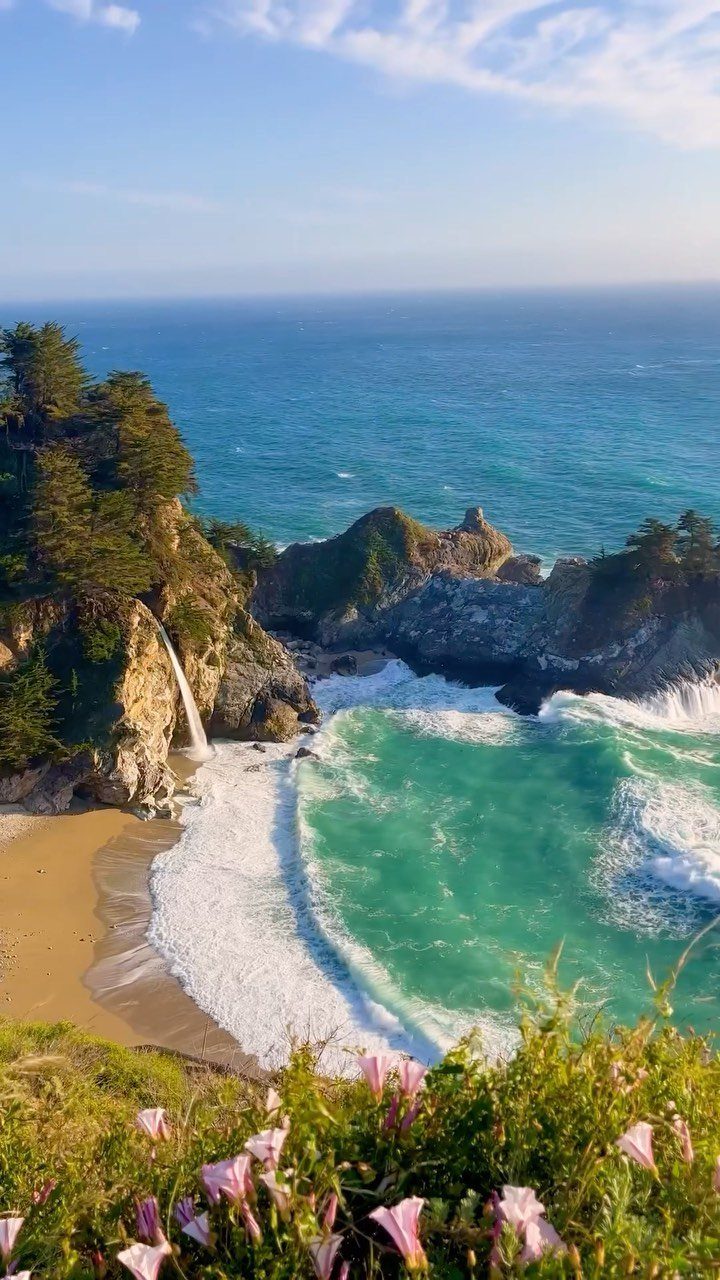 Prettiest Place to Visit: 21 Ideas Around the World 3 Rugged coastline with a waterfall falling onto a beach and turquoise ocean water.