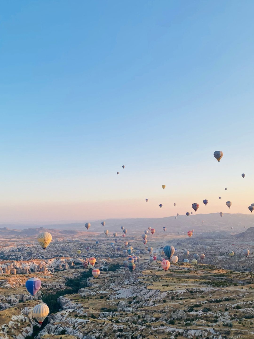 Prettiest Place to Visit: 21 Ideas Around the World 15 Colorful hot air balloons floating over the rocky fairy chimneys of Cappadocia landscape.