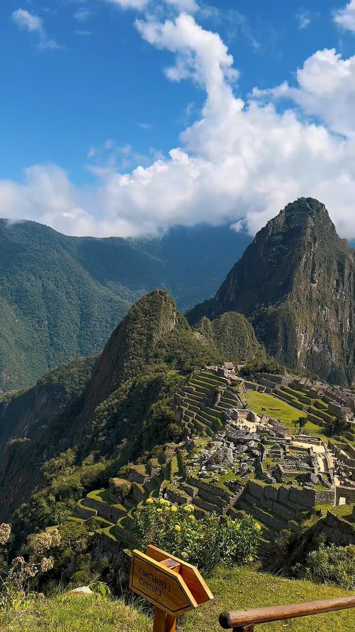 Prettiest Place to Visit: 21 Ideas Around the World 5 Machu Picchu ruins and terraces surrounded by lush green Andean mountain peaks.
