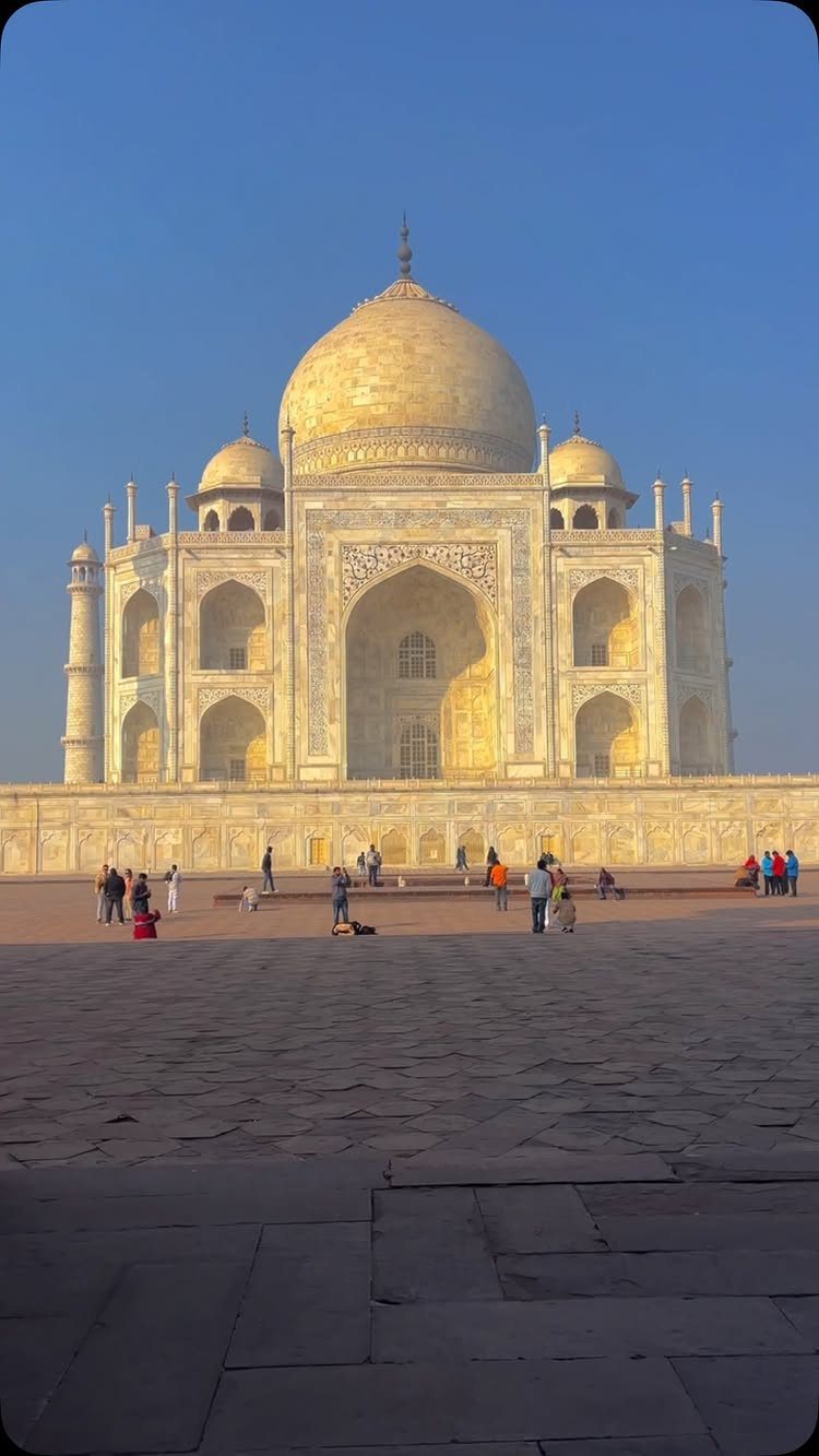 Prettiest Place to Visit: 21 Ideas Around the World 4 Taj Mahal white marble mausoleum with a large dome under a blue sky
