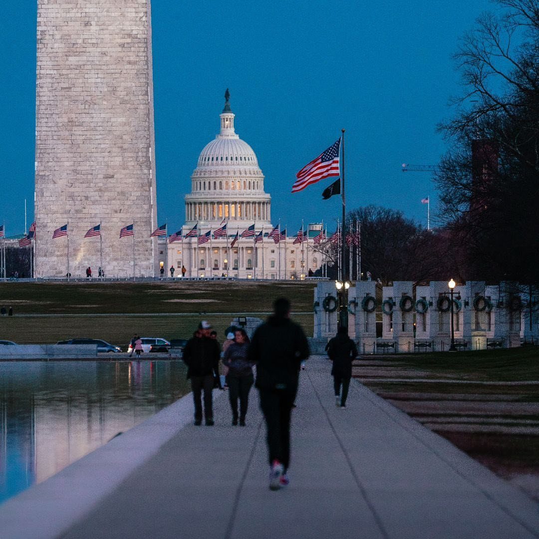 Prettiest Place to Visit: 21 Ideas Around the World 8 Washington Monument and US Capitol building at twilight with people walking nearby.