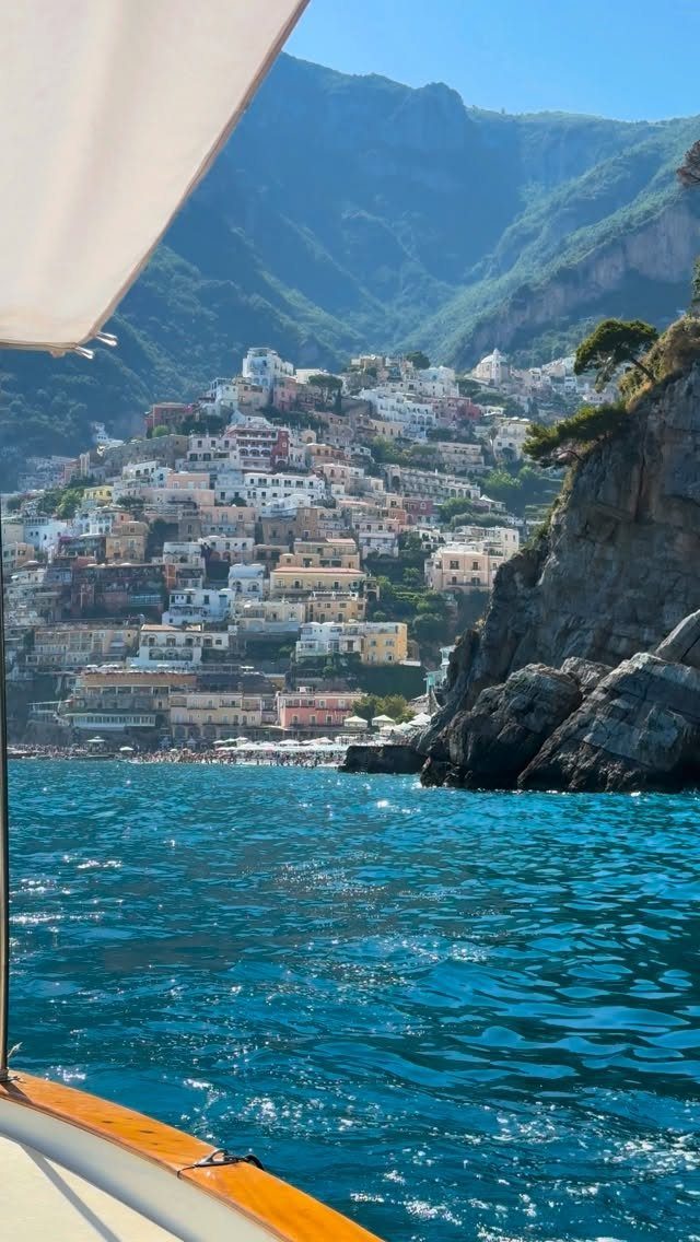 13 Pretty Countries to Visit for Coasts, Peaks and Ruins 1 Colorful hillside town overlooking a bright blue sea with rugged coastal cliffs.