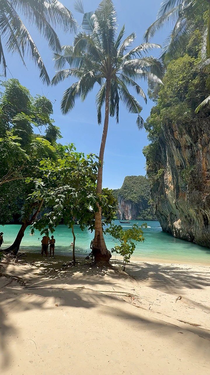 13 Pretty Countries to Visit for Coasts, Peaks and Ruins 9 Tropical beach with white sand, turquoise water, palm trees, and limestone cliffs.
