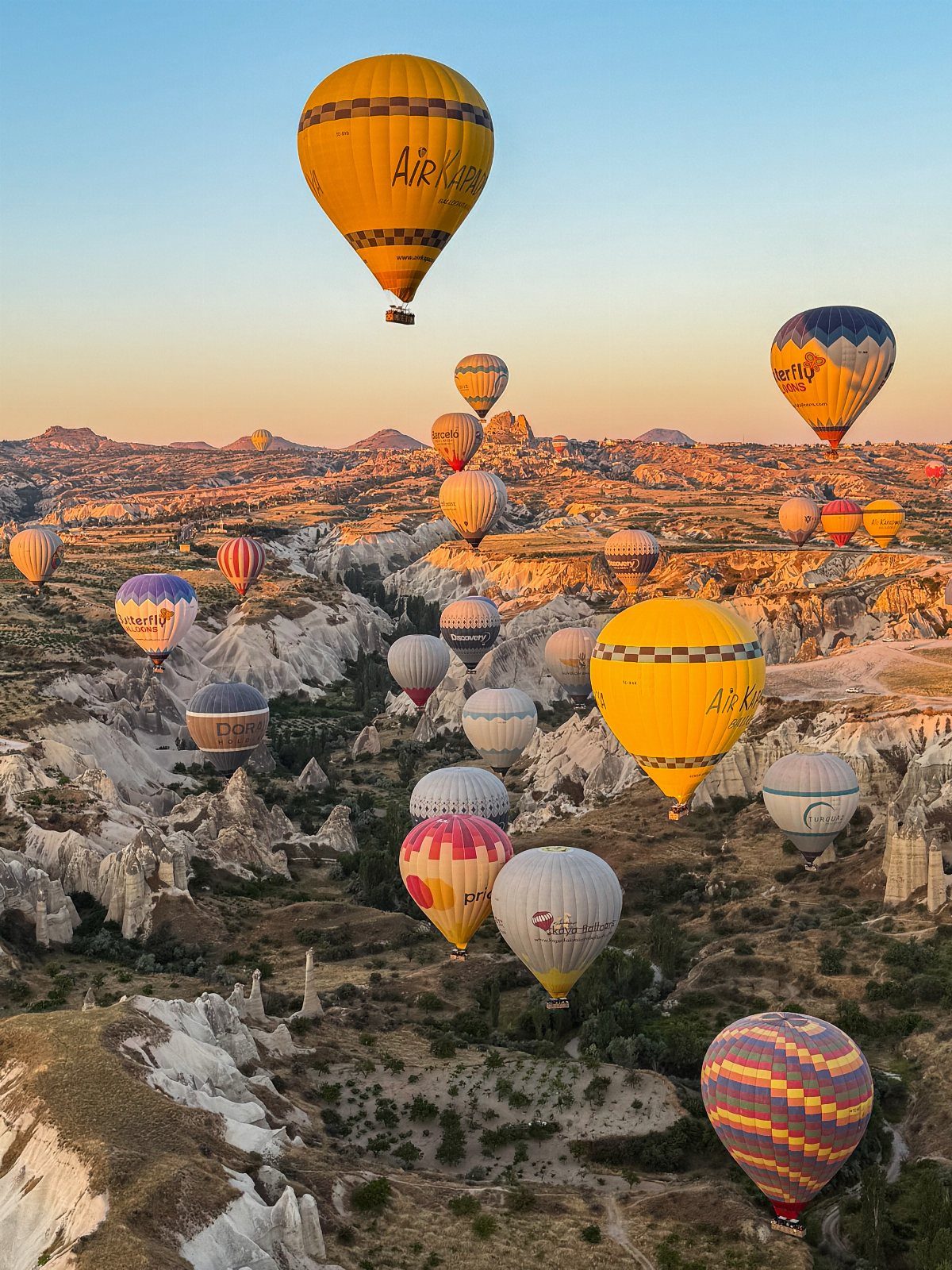26 Pretty Places Around the World, From Fjords to Falls 17 Colorful hot air balloons floating over the fairy chimneys of Cappadocia valley.