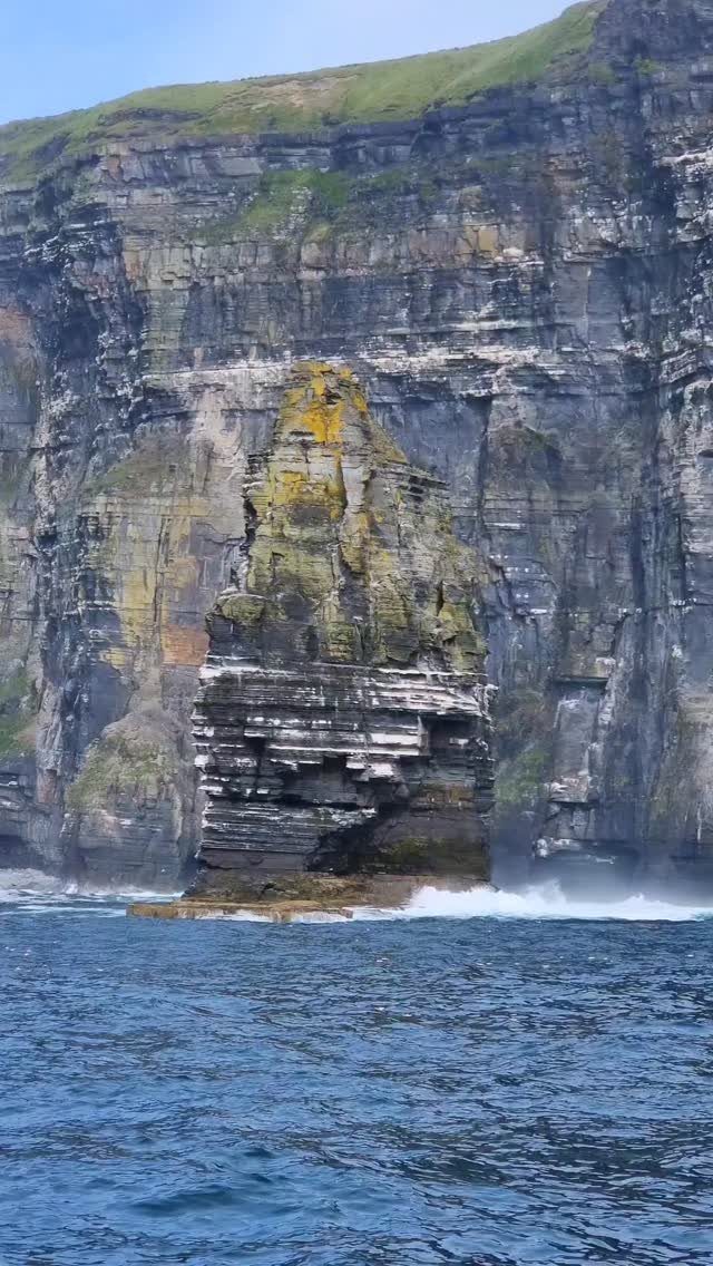 26 Pretty Places Around the World, From Fjords to Falls 19 Jagged sea stack and towering coastal cliffs rising from the blue ocean water.