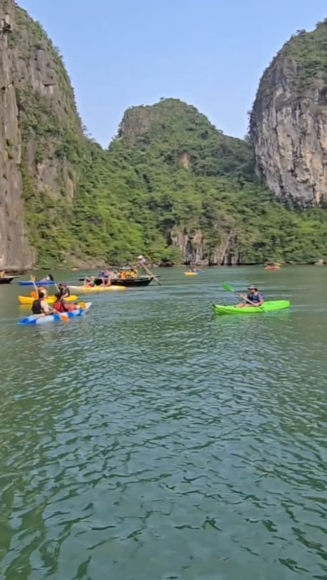 26 Pretty Places Around the World, From Fjords to Falls 18 Kayakers on emerald water surrounded by towering green limestone cliffs in Halong Bay.