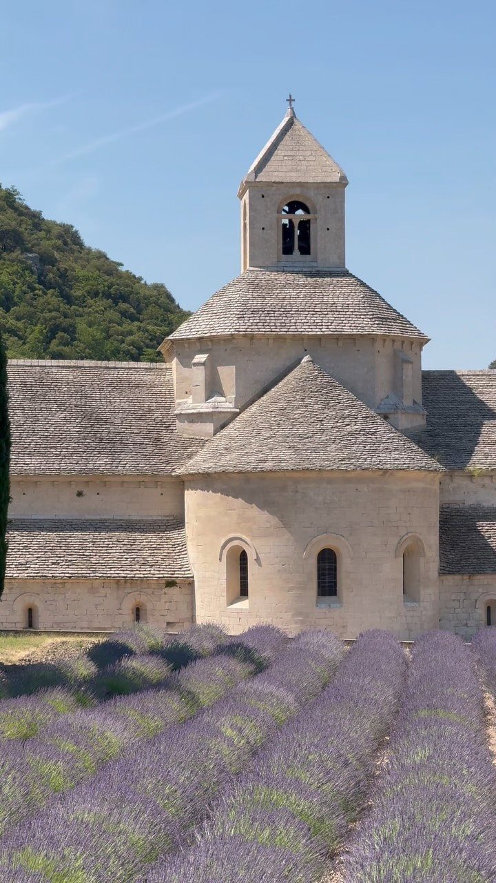 26 Pretty Places Around the World, From Fjords to Falls 2 Stone church with a steeple overlooking rows of purple lavender fields in Provence.