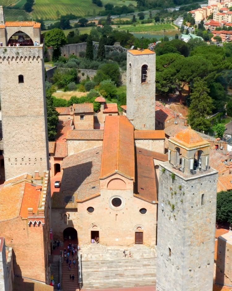 13 Pretty Places in Italy Worth Visiting in 2026 4 Medieval stone buildings and towers with terracotta roofs in a historic Italian city.