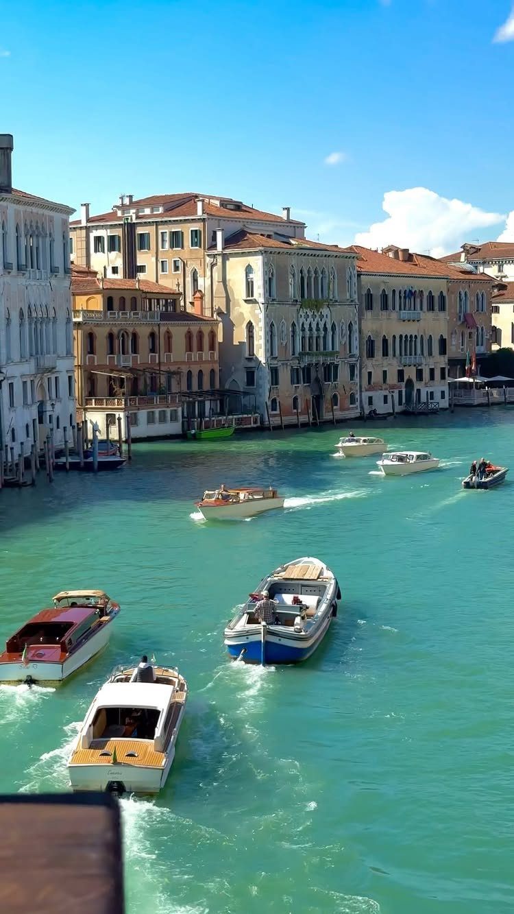 13 Pretty Places in Italy Worth Visiting in 2026 1 Venice canal with turquoise water, motorboats, and historic Italian buildings under blue sky