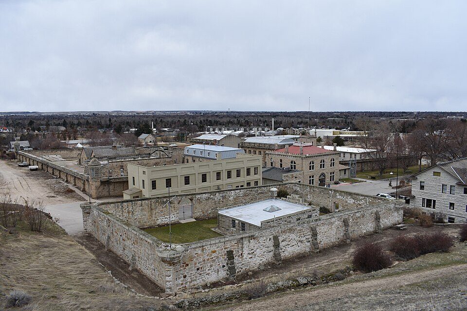7 Sights to See in the US, From Acadia to Old Idaho 7 Old Idaho Penitentiary stone walls and buildings viewed from an elevated perspective.