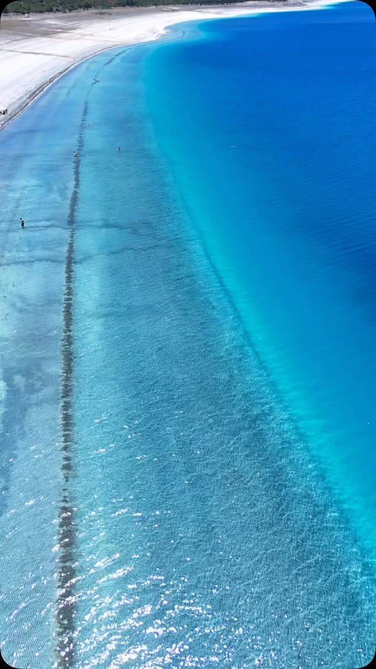 White sandy beach and turquoise waters of Lake Salda seen from above.