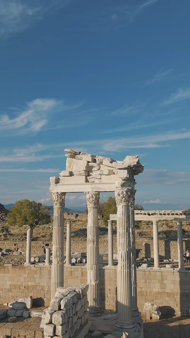 Ancient white marble columns and ruins of the Pergamon Acropolis under blue sky