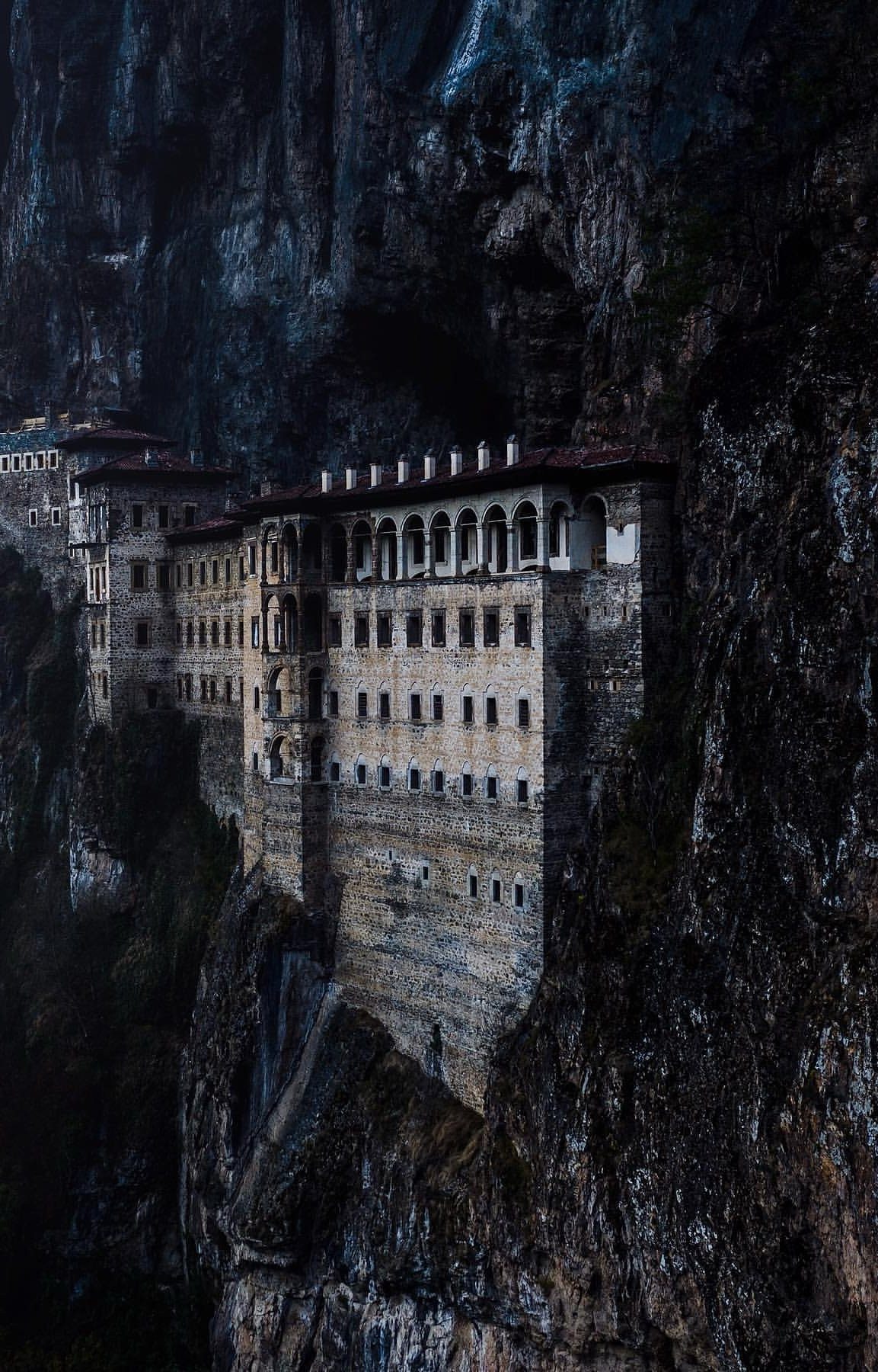 Sumela Monastery built into a steep, dark rocky cliff in Trabzon, Turkey.