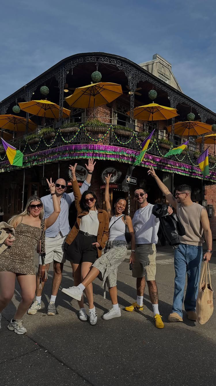 12 Vacation Ideas with Friends, from Cruises to Cancun 12 Six friends posing in front of a decorated building on Bourbon Street in New Orleans.