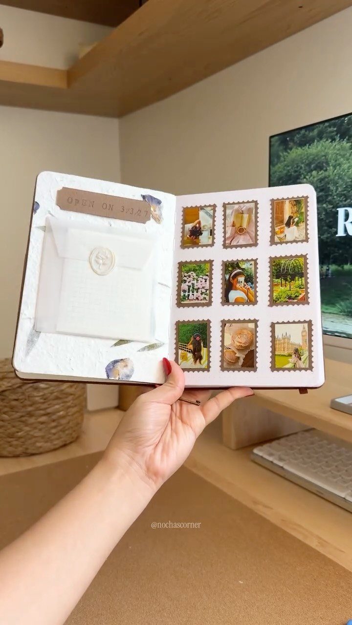 9 Ideas for What to Do on the Plane Besides Scrolling 5 Open scrapbook with a white envelope and a grid of small travel photos.